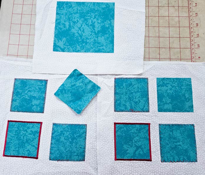 Teal squares on white fabric; HeatnBond, fusible web, sewing, applique, quilting, hemming, fabric adhesive, SoftStretch, Lite, Featherlite, Ultra, sewing tips, crafting, fabric experiments