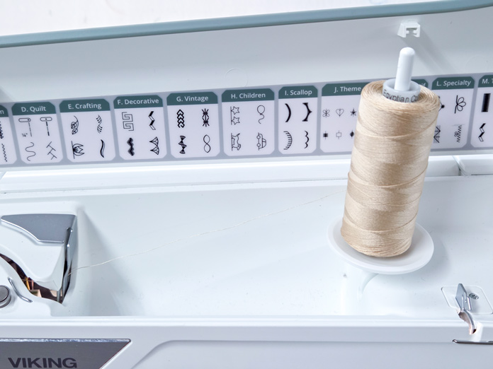 A spool of thread on a sewing machine