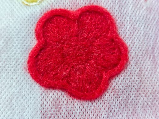 A red felted flower