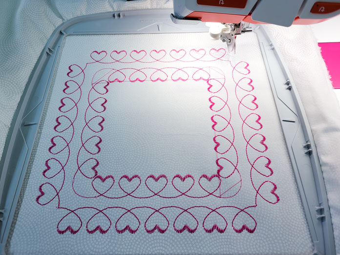 Two squares of heart stitches in a machine embroidery hoop; Husqvarna Viking DESIGNER EPIC 2