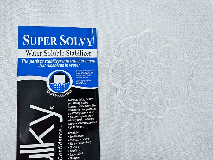 A white machine embroidery design on white fabric