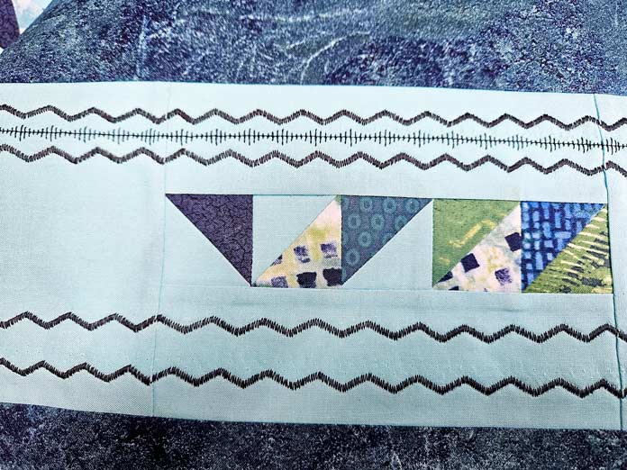 Black stitching on blue fabric