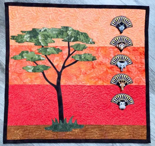 A tree on an orange background with animal buttons