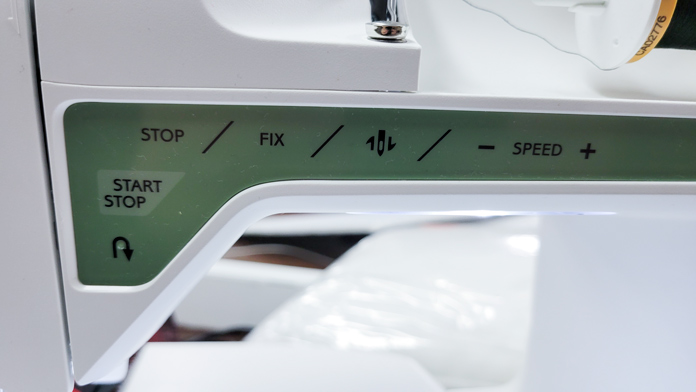 A function panel on a green and white computerized sewing machine; Husqvarna Viking Tribute 150C