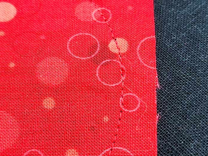Red stitching on red fabric
