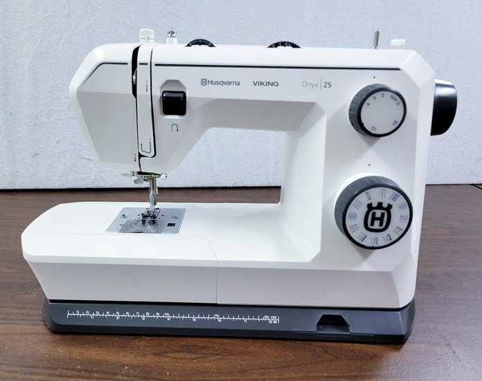 A gray and white sewing machine; Husqvarna VIKING ONYX 25 sewing machine