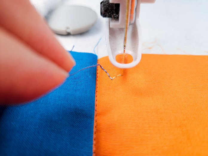 Orange and blue fabric with an embroidery presser foot; Husqvarna VIKING DESIGNER EPIC 3