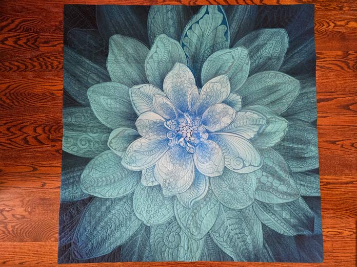 A quilt with a large blue flower; quilting, embroidery machine, machine embroidery, quilting techniques, Husqvarna VIKING, quilt labels, embroidery software, quilt embellishments, quilting tools, QUILTsocial, Husqvarna VIKING Designer Epic 3, Designer Epic 3