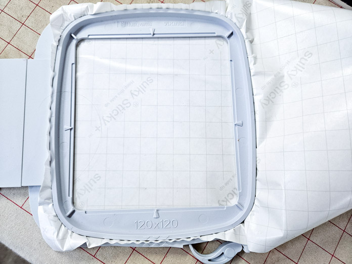 White paper in a grey machine embroidery hoop