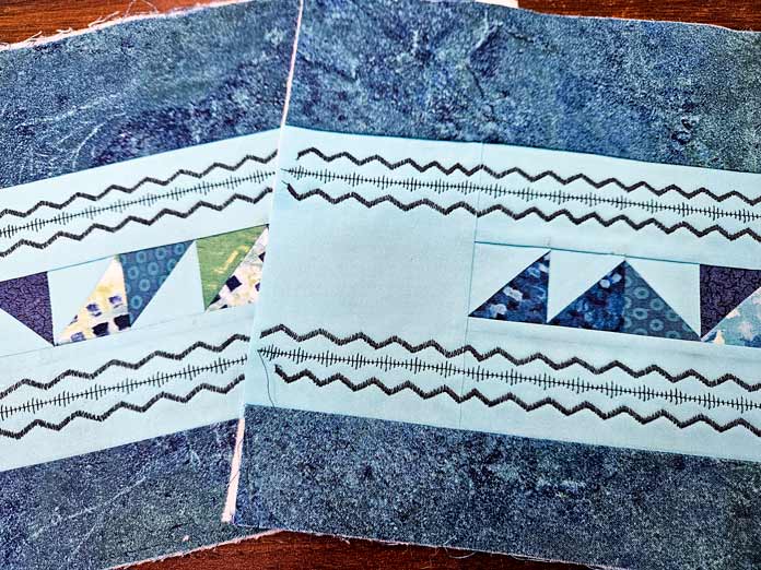 Dark blue stitching on blue fabric