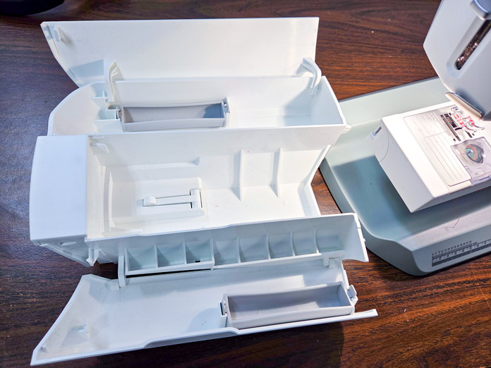 A white accessory tray for a sewing machine