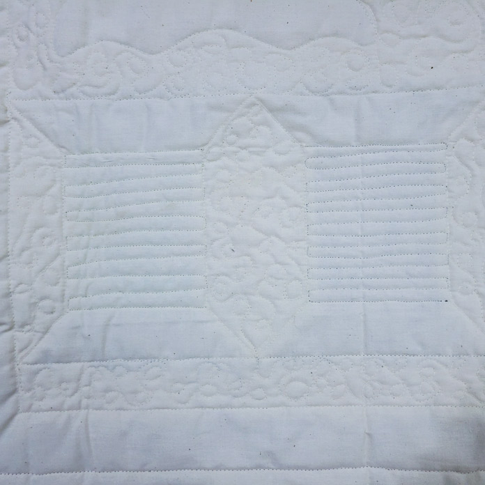 Cream quilting stitches on a cream fabric