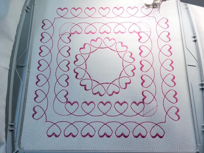 Two squares of hearts and one circle of hearts in a machine embroidery hoop; Husqvarna Viking DESIGNER EPIC 2