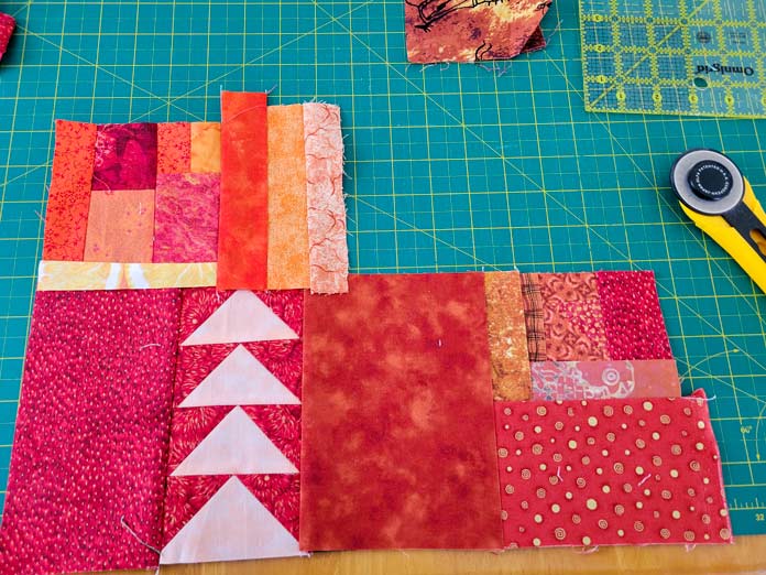 Pieces of orange fabric sewn together on a green cutting mat; Husqvarna Viking DESIGNER EPIC 2