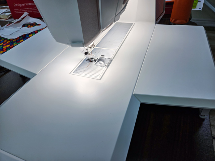 Two white hoops supports on a white sewing machine; Husqvarna VIKING DESIGNER EPIC 3