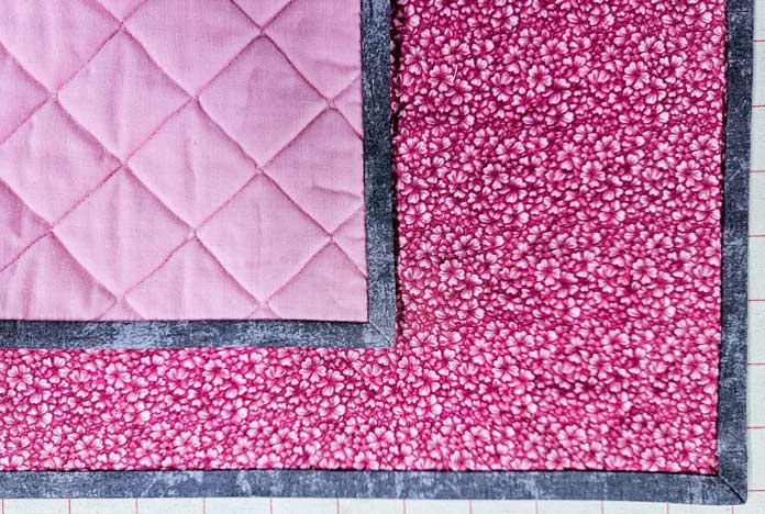 Pink fabric with grey edges; HeatnBond Lite, quilt binding, fusible web, fabric crafts