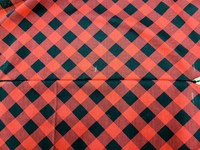 A red and black plaid fabric with an invisible zipper