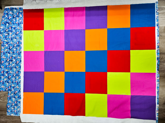 A quilt with large multi-colored squares