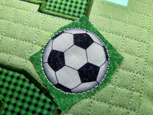 Soccer ball fabric on green fabric