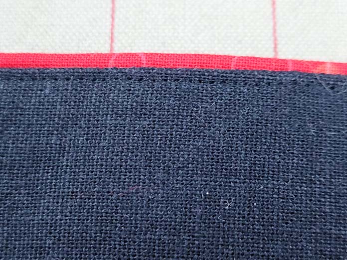 A red strip on the edge of black fabric