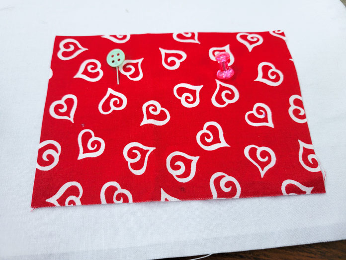 White hearts on red fabric