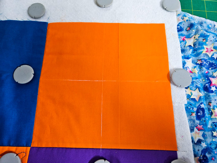 An orange quilt square in a metal hoop with eight magnets; Husqvarna VIKING DESIGNER EPIC 3, Husqvarna VIKING Quilters Metal Embroidery Hoop 200mm by 200mm