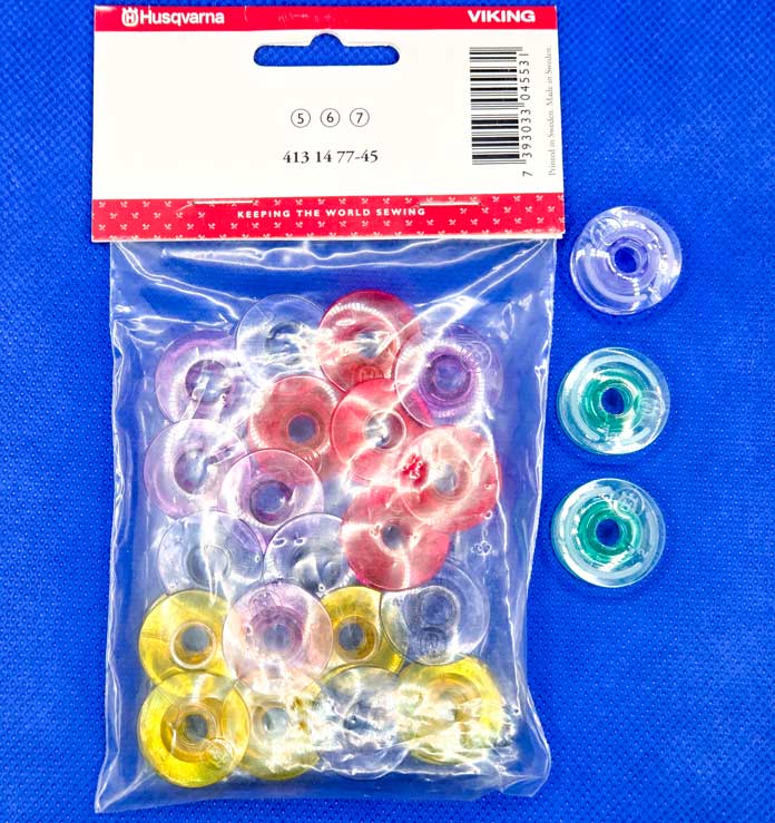 Multi-colored bobbins for a sewing machine
