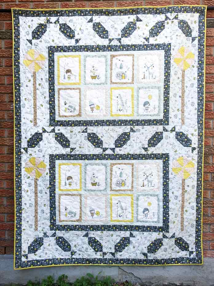 A yellow, black and white quilt. INFINITI Embroidery Scissors, INFINITI Sewing Scissors, INFINITI Tailor Scissors, LDH One Piece Thread Snips, LDH Pinking Shears, Whimsicals collection by Michael Miller Fabrics, UNIQUE Small Seam Ripper, UNIQUE quilting Clever Clips, UNIQUE Cutting Mats, Sew Easy rulers, Vivace Quilting Accessories Tote