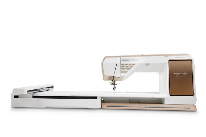 A rose gold and white sewing machine; Husqvarna VIKING DESIGNER EPIC 3