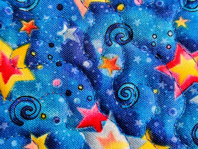 Blue stitching on blue fabric