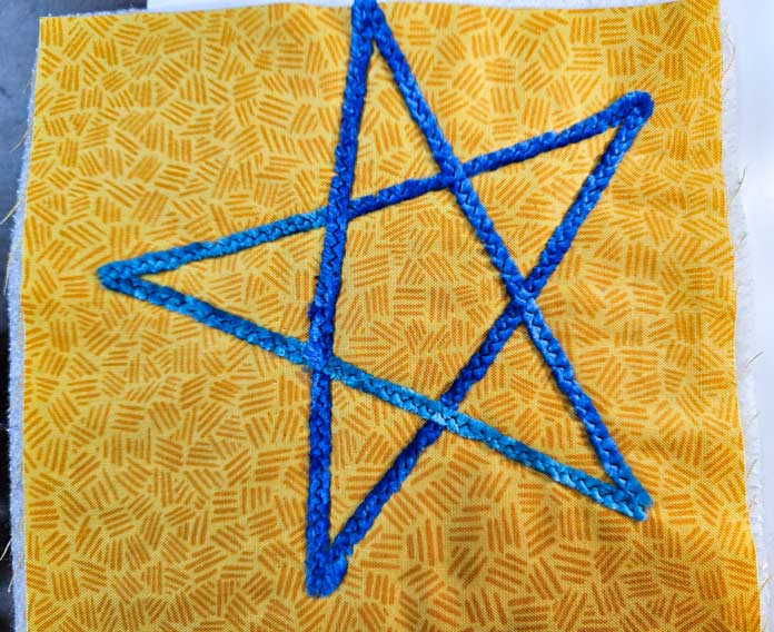 A blue star outline on yellow fabric