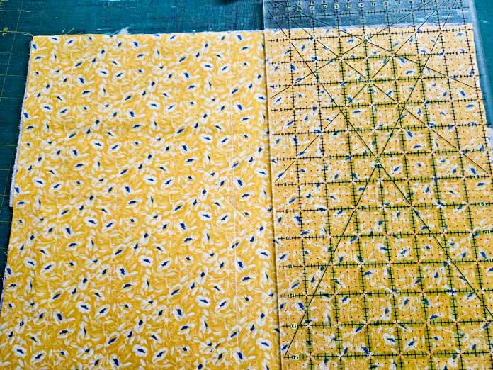 A quilter’s ruler on yellow fabric