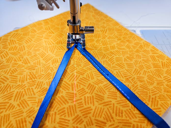 Blue ribbon on yellow fabric