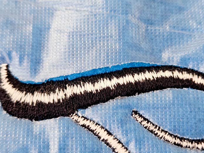 Black and white stitches on a water-soluble stabilizer