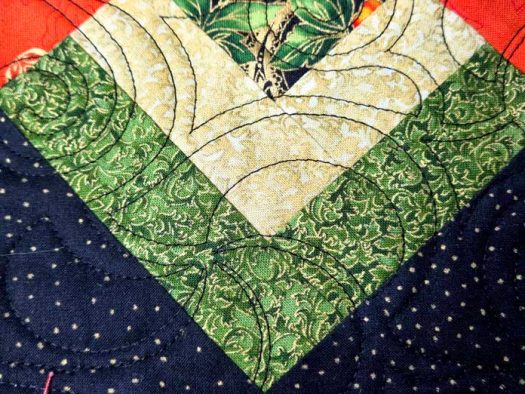 Black stitches on green and black fabric