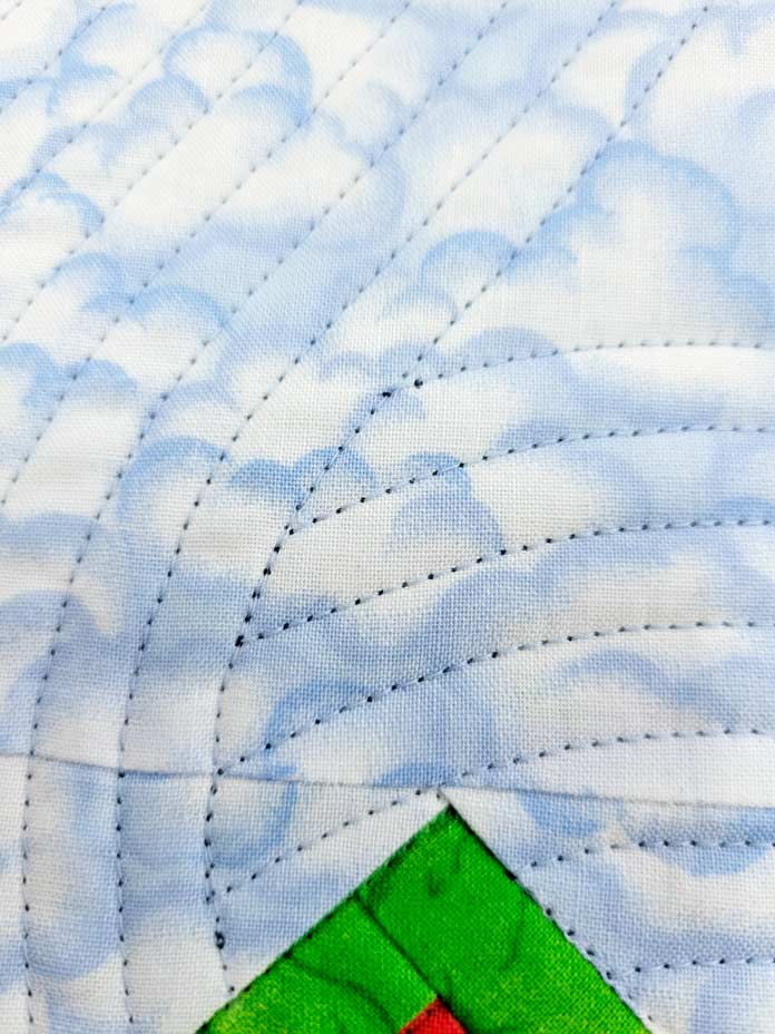 Lines of blue stitching on blue fabric