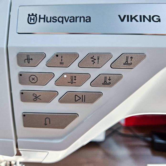 The push buttons on a function panel on a sewing machine; Husqvarna VIKING DESIGNER EPIC 3