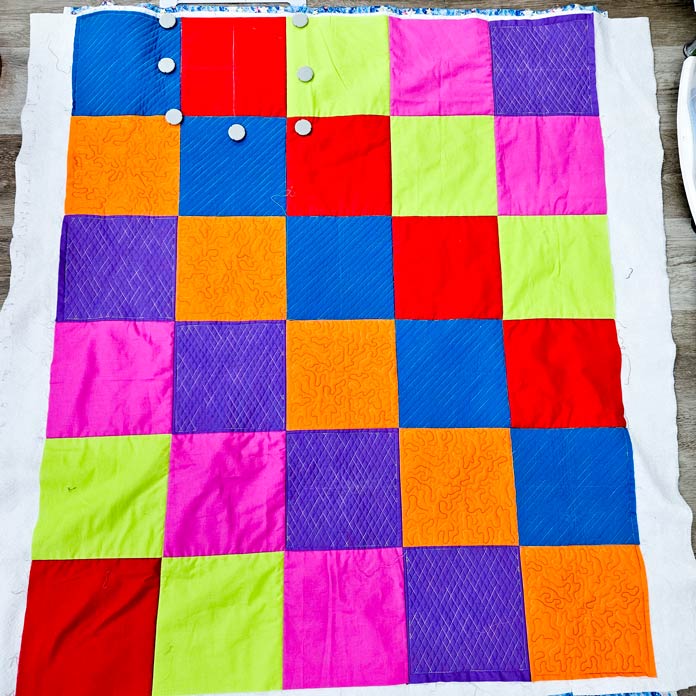 A colorful quilt with half the blocks quilted; Husqvarna VIKING Quilters Metal Embroidery Hoop 200mm by 200mm