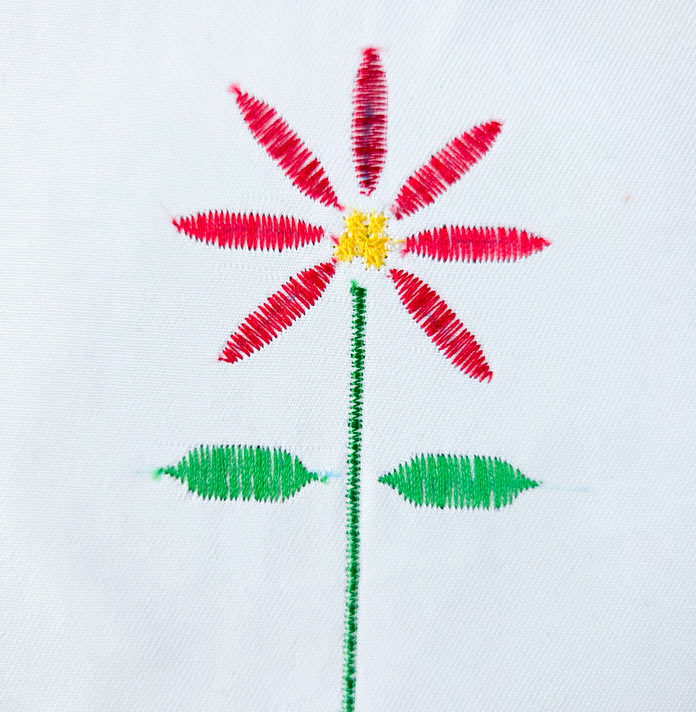 A flower stitch in red and green thread
