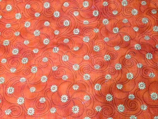 Black stitches on orange fabric