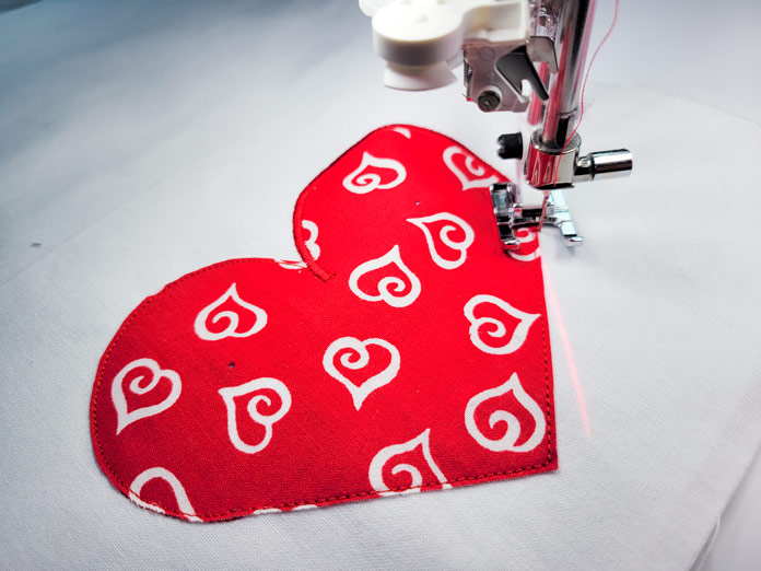 A red and white heart on white fabric; Husqvarna Viking Designer EPIC 2