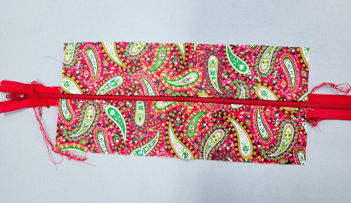 Red and green fabric with a red zipper
