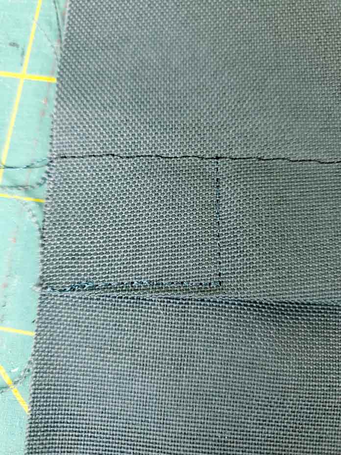 A square of stitching on green fabric; Husqvarna Viking Designer Sapphire 85
