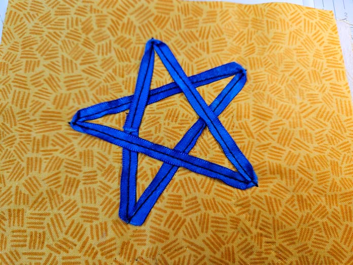 A blue star on yellow fabric