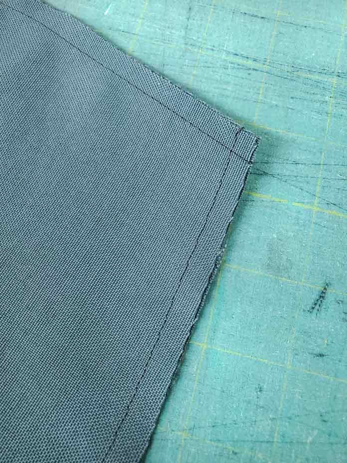 Two lines of stitching on green fabric. Husqvarna Viking Designer Sapphire 85, Inspira EZ Snip Curved Scissors