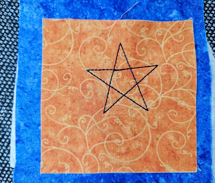 A star outline on gold fabric