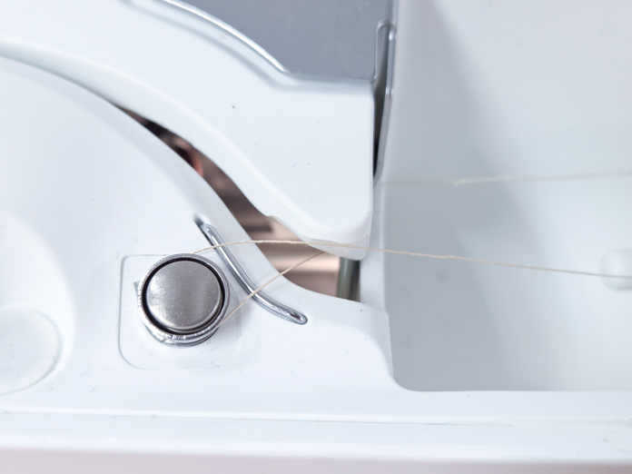 A thread around a pre-tension disk on a sewing machine