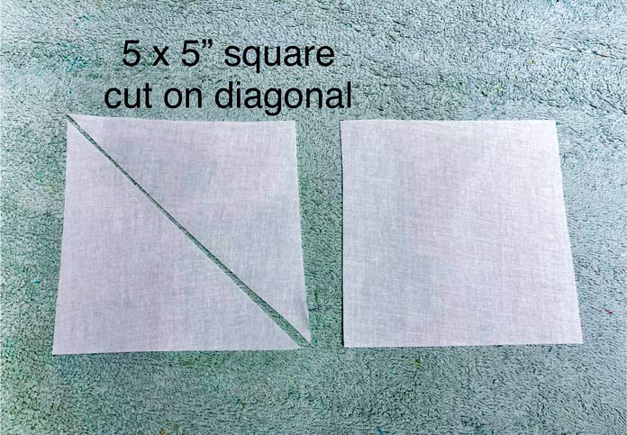 Cutting fabric on the diagonal from 2 – 5” x 5” squares to make 4 triangles