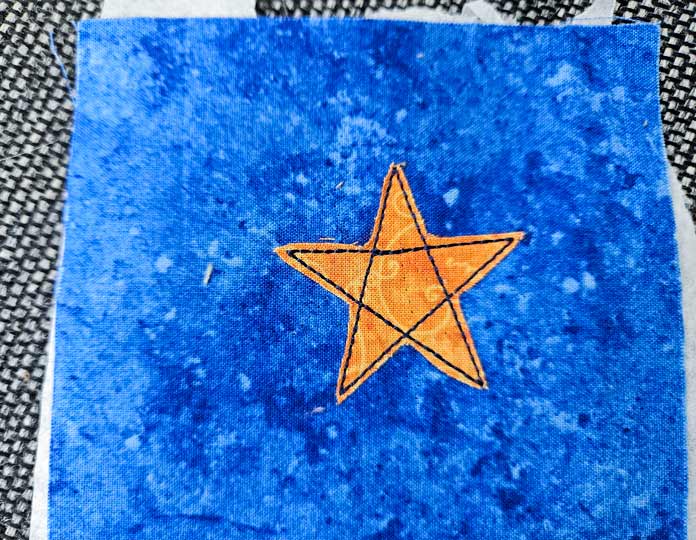 A yellow star on blue fabric