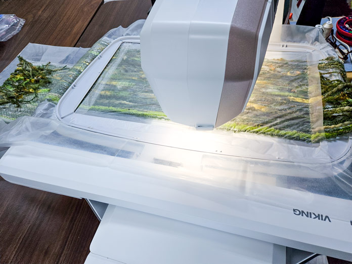 An embroidery machine with yarn in the hoop